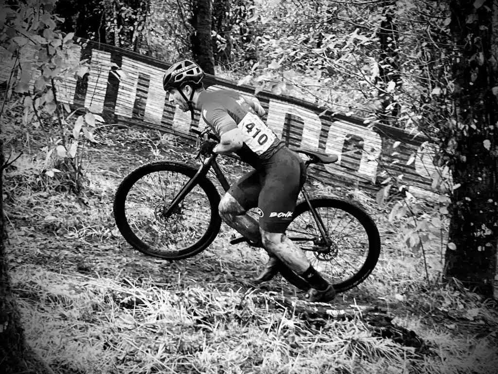 Man pushing bike uphill